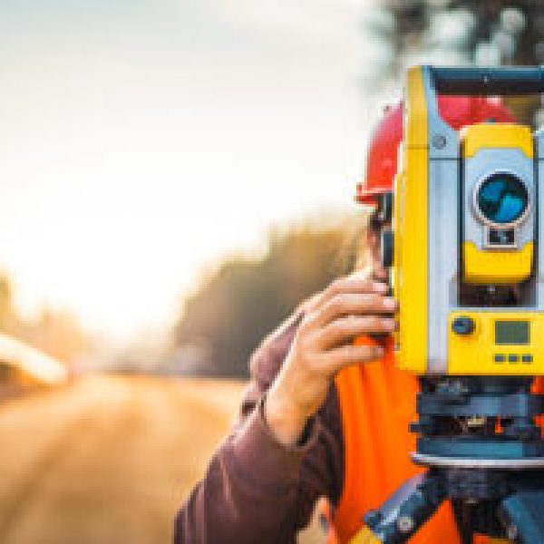 Surveyor engineer with equipment (theodolite or total positionin